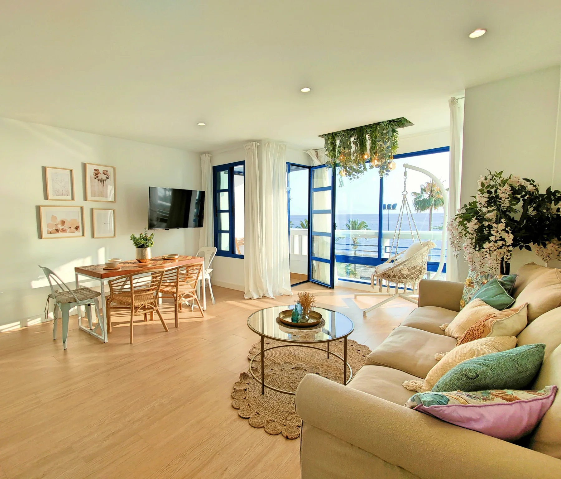 Bright coastal living room in Málaga with doors opening towards the sea